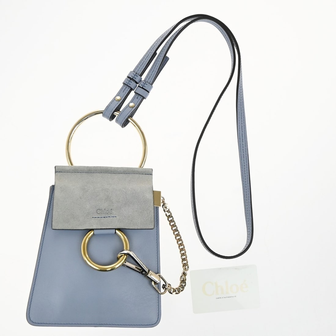 Faye Bracelet Blue Leather Suede Crossbody Bag by Chloe: Faye Bracelet Blue Leather Suede Crossbody Bag by Chloe This Chloe Faye Bracelet Crossbody Bag is crafted from leather in a blue color and features a distinctive bracelet handle. Designed for women, i