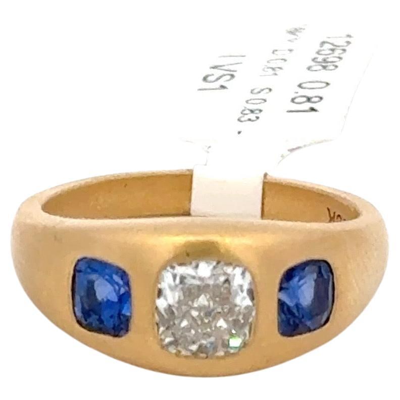 GIA Certified Three Stone Cushion Diamond Sapphire Ring 1.64 CTS in 18K Yellow Gold: GIA Certified Three Stone Cushion Diamond Sapphire Ring 1.64 CTS in 18K Yellow Gold This elegant contemporary three stone gypsy ring showcases a stunning GIA Certified cushion cut diamond at its cente