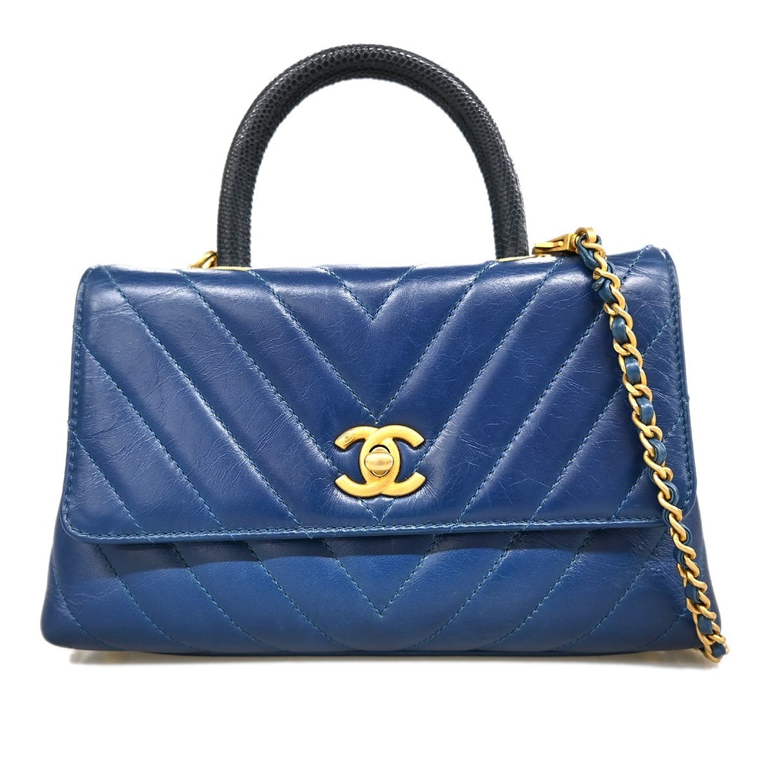 Blue Leather Coco Handle Top Handle Bag by Chanel with Turn Lock: Blue Leather Coco Handle Top Handle Bag by Chanel with Turn Lock This Chanel Coco Handle 2way handbag is crafted from blue calfskin leather and features a medium-sized top handle design. It is accente
