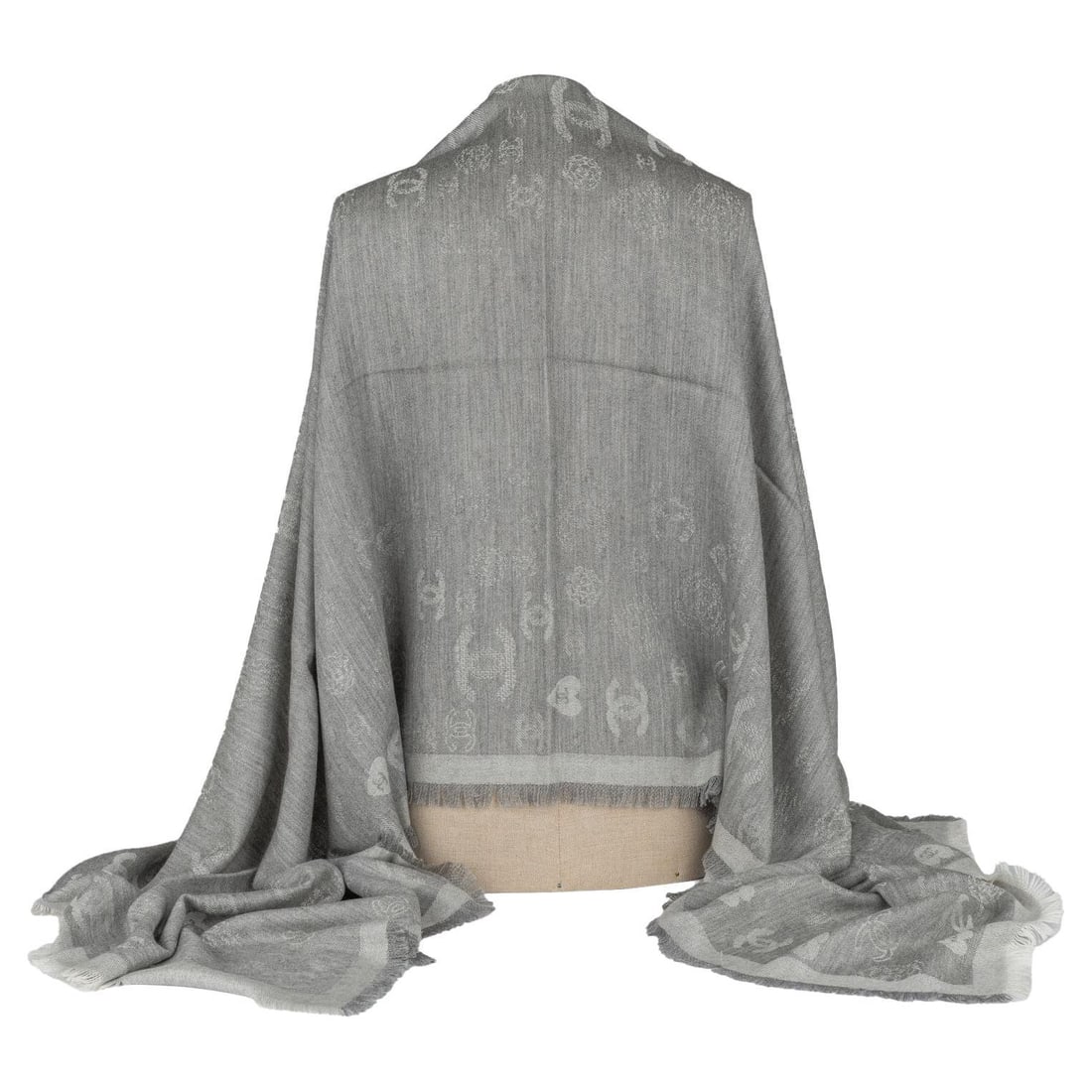 Chanel Grey Cashmere Shawl with Hearts and CC Logos: Chanel Grey Cashmere Shawl with Hearts and CC Logos This exquisite Chanel Cashmere Shawl in grey combines luxury and elegance. Crafted in Italy, it features a delightful pattern of hearts and small CC