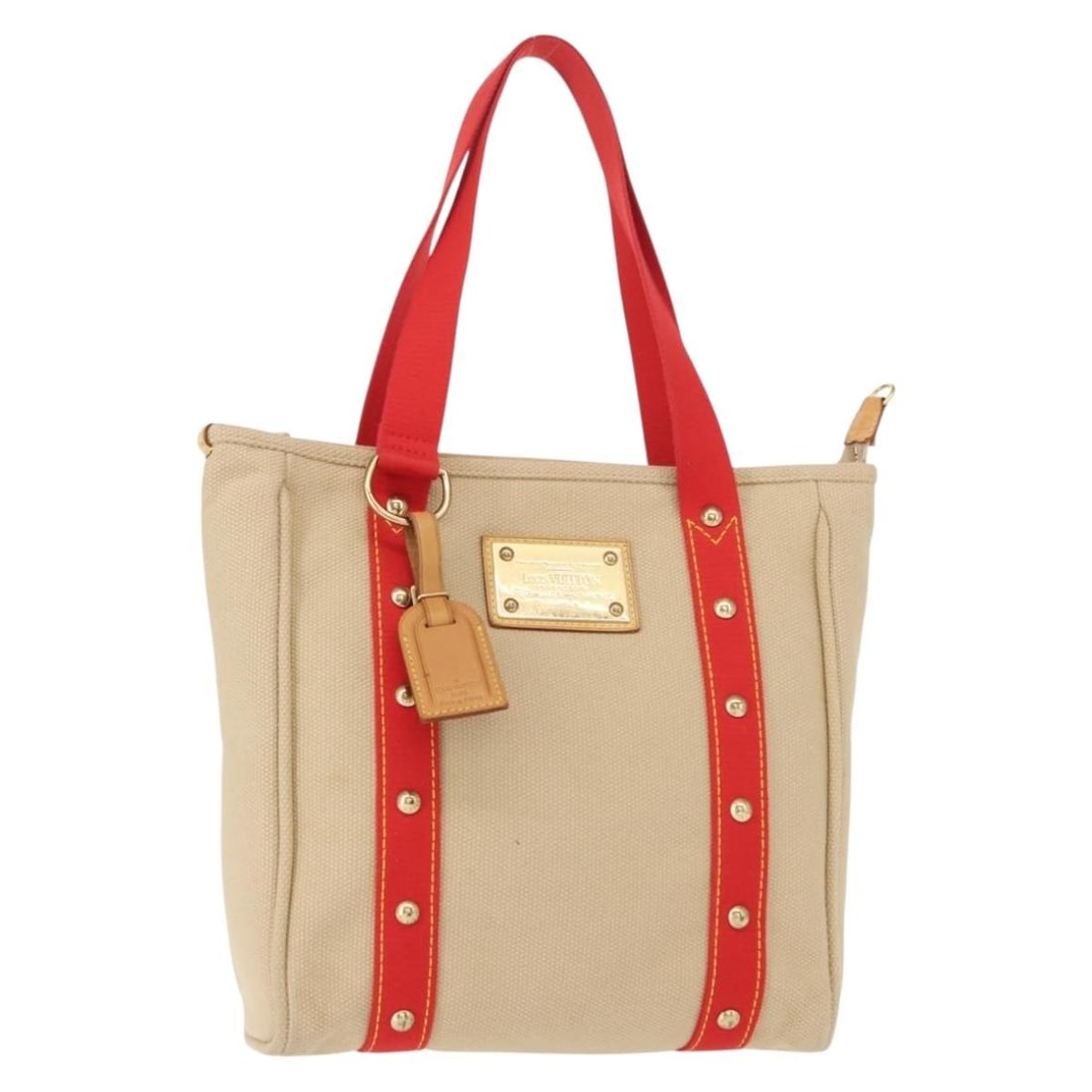 Beige Canvas Antigua Tote Bag by Louis Vuitton: Beige Canvas Antigua Tote Bag by Louis Vuitton This Louis Vuitton Antigua Tote is crafted from beige canvas and designed for women. The bag features a spacious interior and sturdy handles, making it b