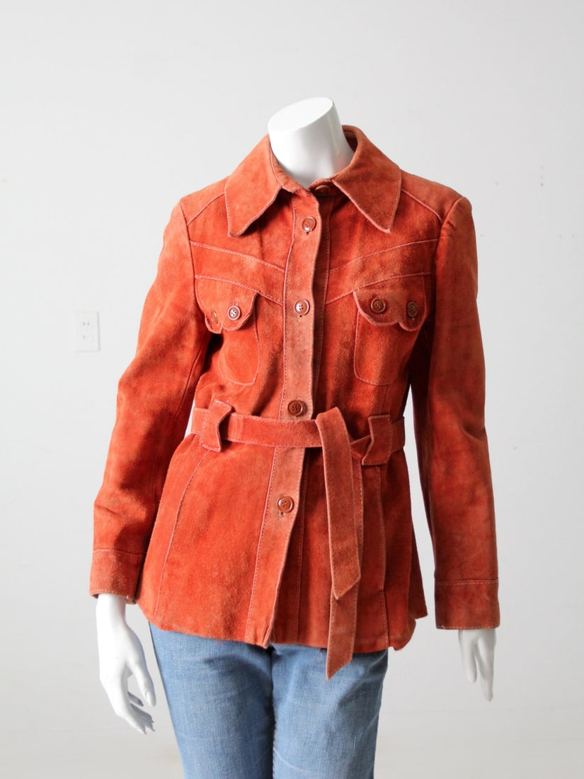 1960s Burnt Orange Suede Belted Leather Jacket by Kmart Size 12: 1960s Burnt Orange Suede Belted Leather Jacket by Kmart Size 12 This authentic 1960s suede leather jacket features a rich burnt orange color and is crafted by Kmart. It is designed with a classic belt