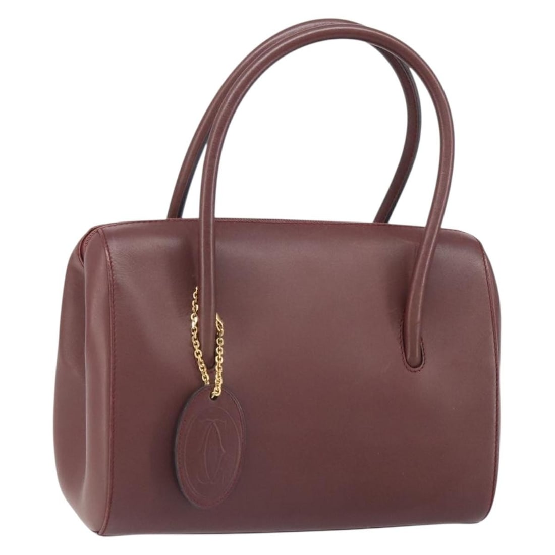Cartier Must Line Bordeaux Leather Handbag with Gold Accents: Cartier Must Line Bordeaux Leather Handbag with Gold Accents This is a Cartier Must Line handbag crafted from Bordeaux leather with gold-tone accents. The bag features a structured silhouette and a si