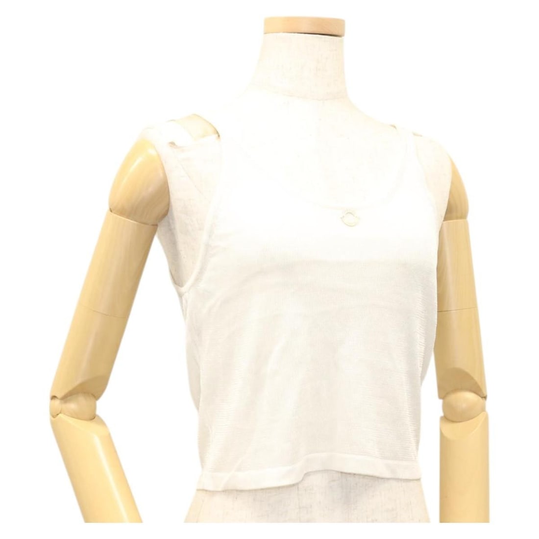 White Polyester Tank Top by CHANEL with Knitted CC Detail: White Polyester Tank Top by CHANEL with Knitted CC Detail This CHANEL women's tank top is crafted from white polyester knit fabric. It features the iconic CC logo detail and is designed with a back le