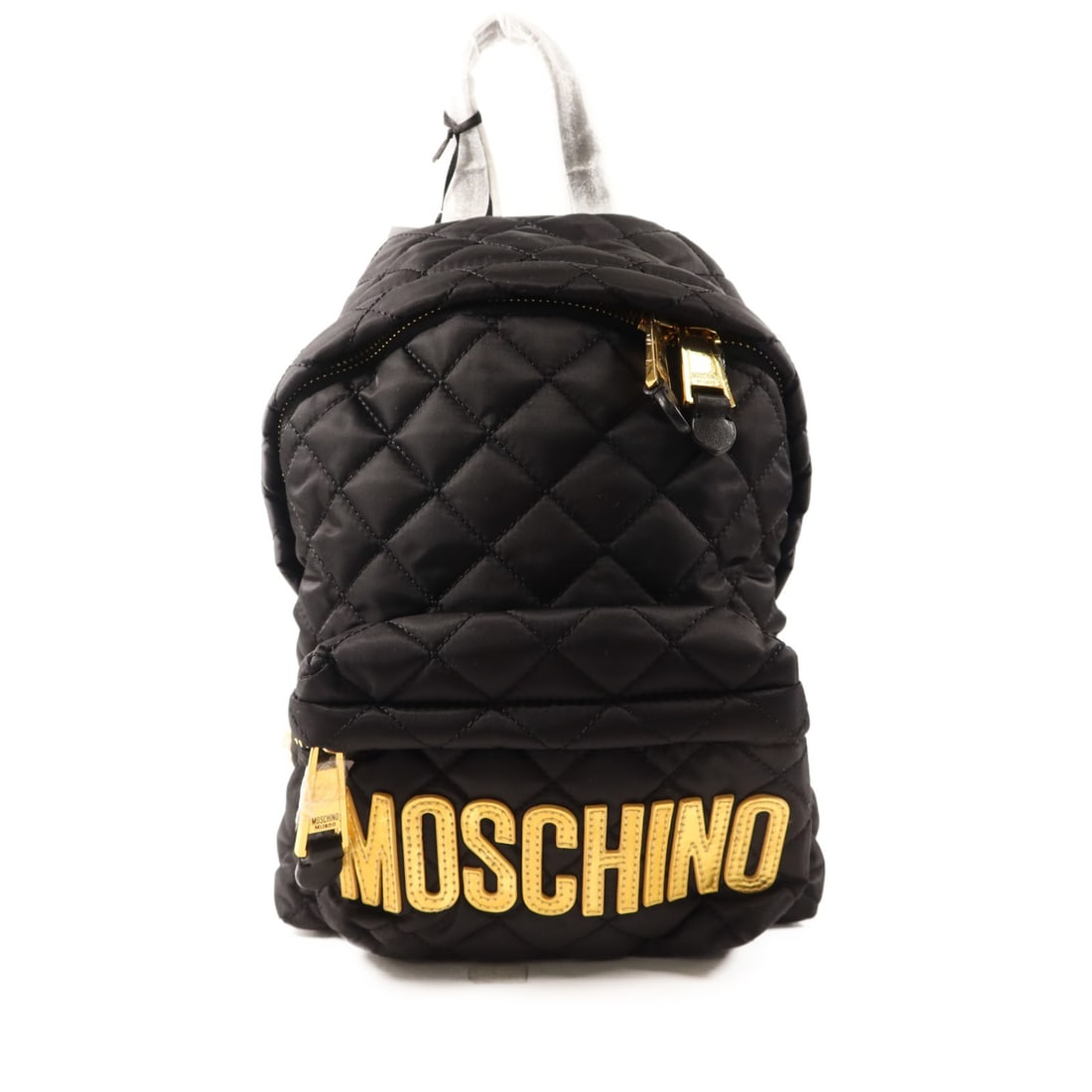 Moschino Black Nylon Backpack with Gold Tone Hardware: Moschino Black Nylon Backpack with Gold Tone Hardware This Moschino rucksack backpack features a sleek black nylon exterior, designed for women. The bag is in pristine, un-used condition and offers a 