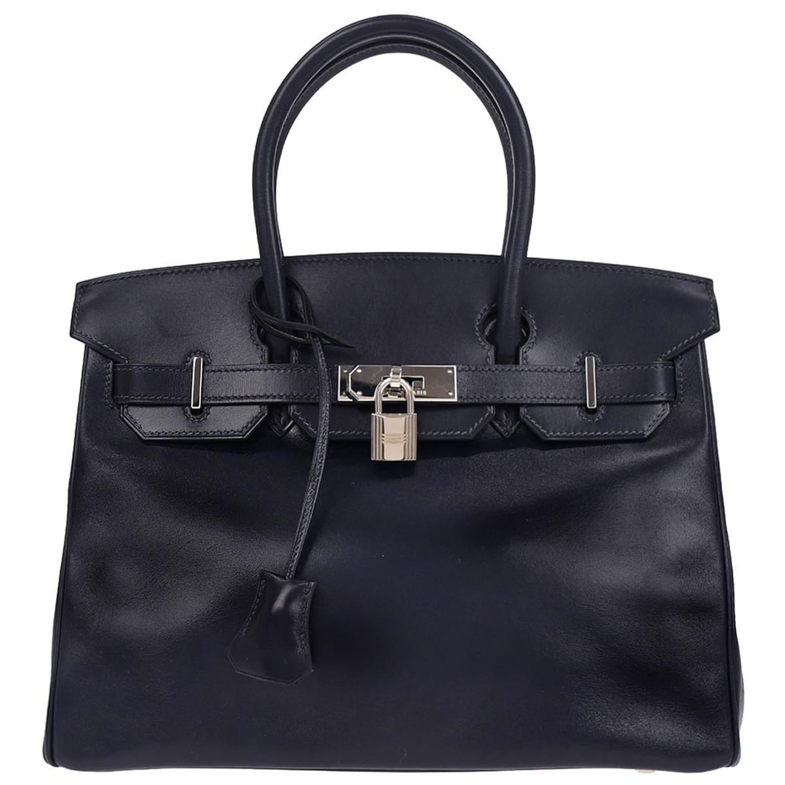 Birkin 30 Blue Indigo Box Calf Medium Top Handle Bag with Lock: Birkin 30 Blue Indigo Box Calf Medium Top Handle Bag with Lock This Hermes Birkin 30 handbag features a sleek blue indigo leather exterior with double handles and a secure lock accent. Designed in a c