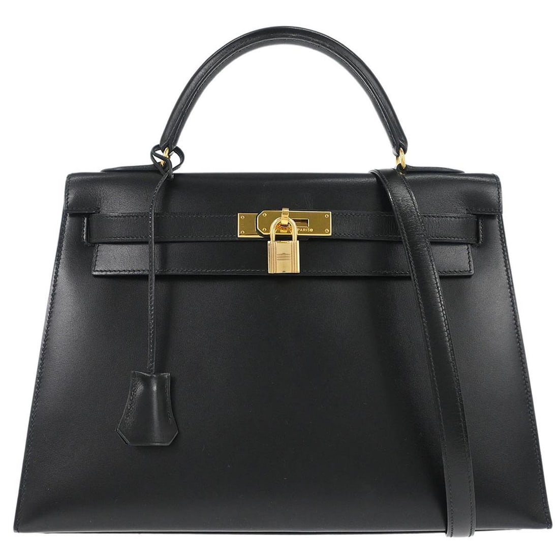 Black Leather Kelly 32 Sellier Top Handle Bag with Gold Hardware by Hermes: Black Leather Kelly 32 Sellier Top Handle Bag with Gold Hardware by Hermes This Hermes Kelly 32 Sellier is a medium-sized top handle handbag crafted from black Box Calf leather. It features a structur