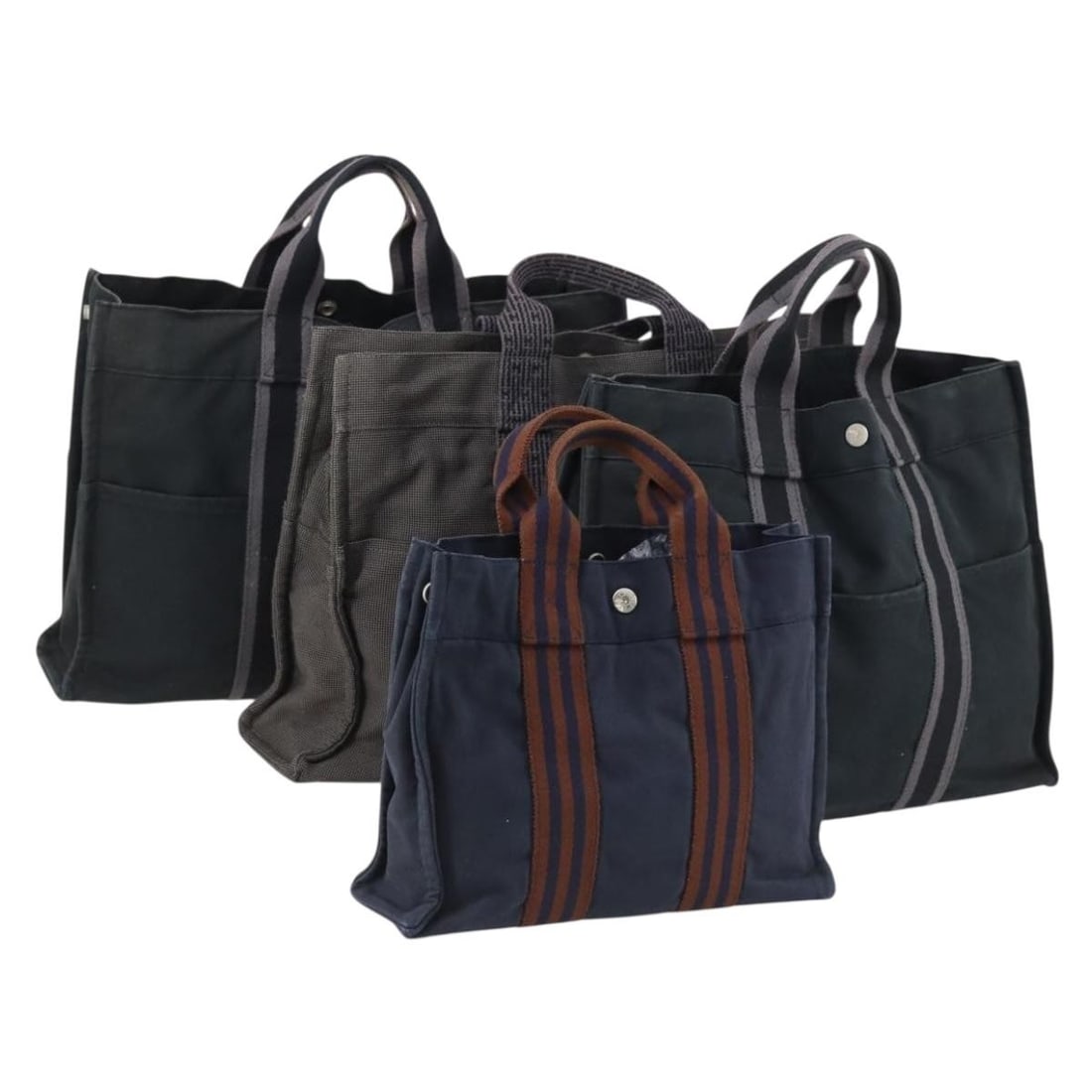 HERMES Canvas Tote Bag 4 Piece Set Black Navy Khaki Authentic: HERMES Canvas Tote Bag 4 Piece Set Black Navy Khaki Authentic This HERMES Tote Bag is crafted from durable canvas and showcases a stylish combination of black, navy, and khaki colors. Designed for pra