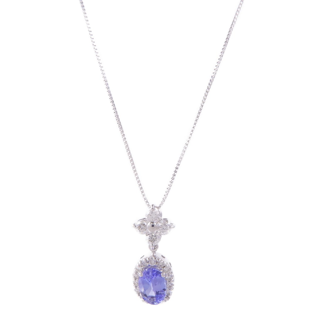 Tanzanite Diamond Necklace in 18K White Gold by JEWELRY: Tanzanite Diamond Necklace in 18K White Gold by JEWELRY This exquisite Tanzanite Diamond Necklace is crafted from 18K white gold, showcasing a stunning blue tanzanite as the main stone. The necklace f