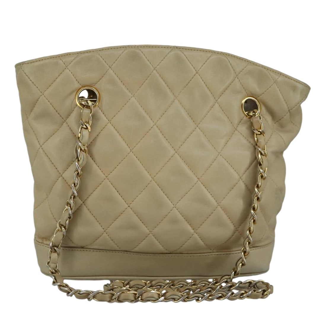 Beige Lambskin Matelasse Shoulder Purse by CHANEL with Gold Chain CC Logo: Beige Lambskin Matelasse Shoulder Purse by CHANEL with Gold Chain CC Logo This CHANEL Matelasse chain shoulder bag is crafted from beige lambskin leather and features gold-tone CC hardware. Designed f