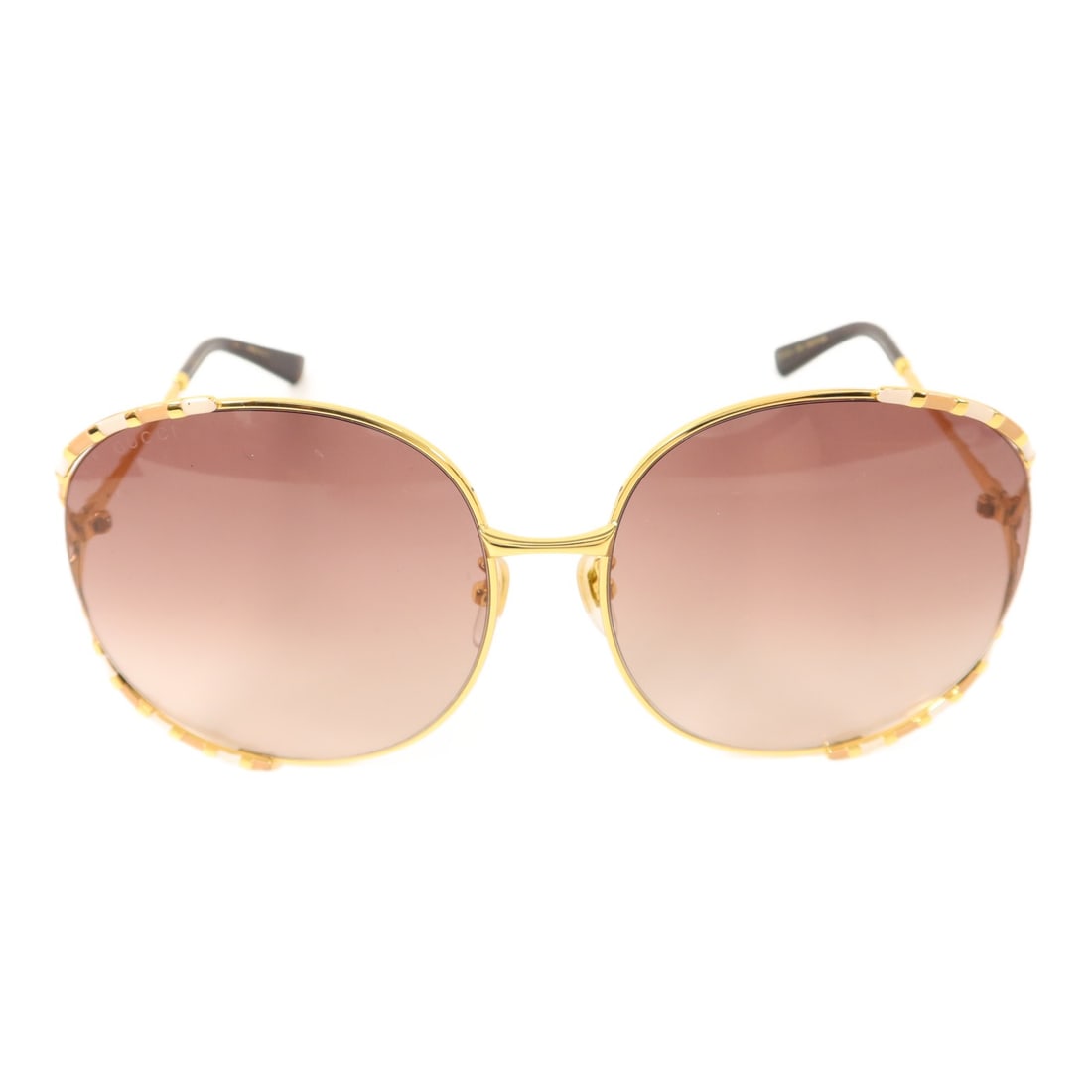 GG0595S Gold Metal Sunglasses by Gucci for Women: GG0595S Gold Metal Sunglasses by Gucci for Women These GUCCI GG0595S sunglasses feature a gold-tone metal frame and are designed for women. Made in Italy, they offer a stylish and sophisticated access