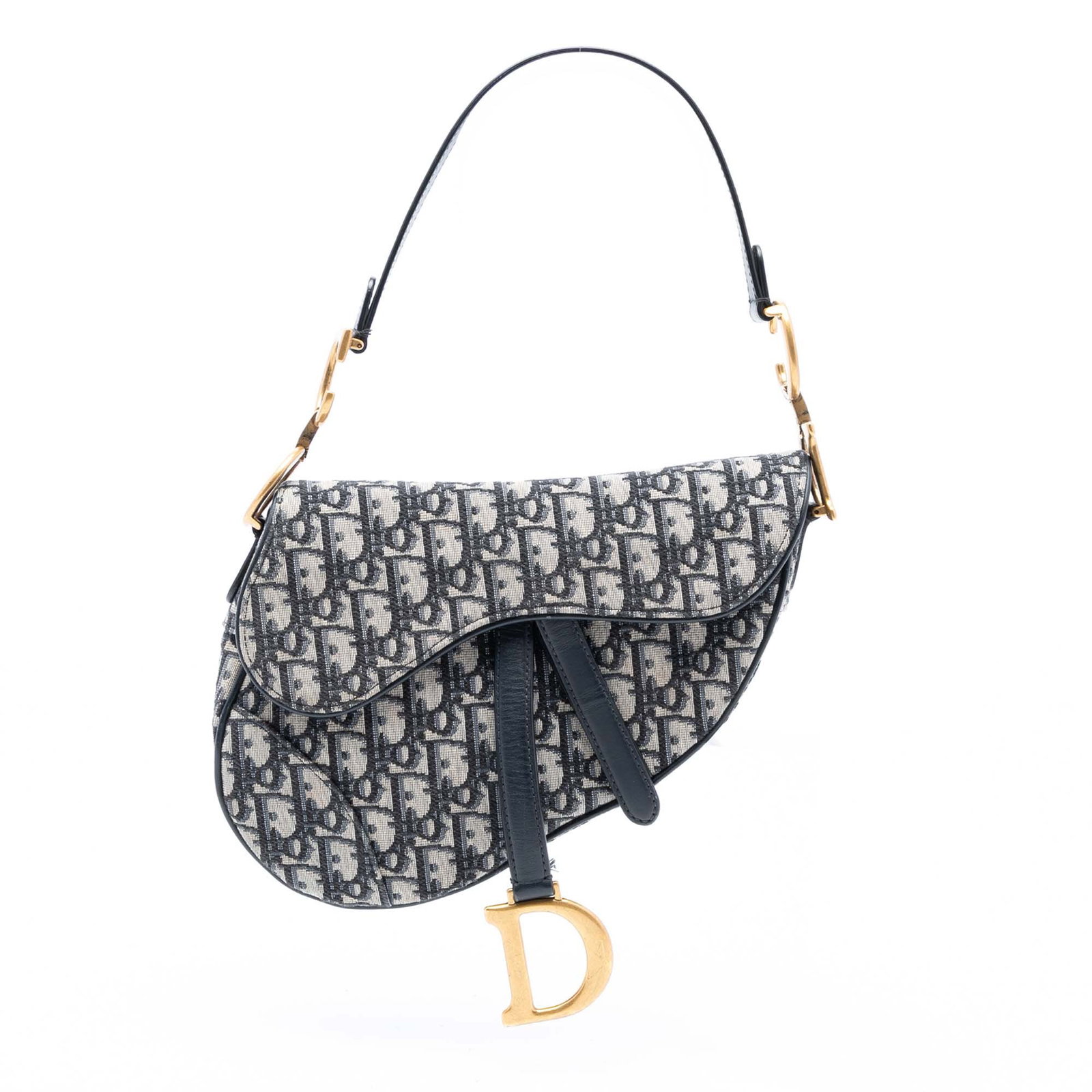 Blue Dior Saddle Bag in Oblique Canvas with Leather Trim: Blue Dior Saddle Bag in Oblique Canvas with Leather Trim This Dior Oblique Canvas Saddle Bag features a blue canvas body with leather trim, a flat leather strap, a front flap with magnetic closure, an