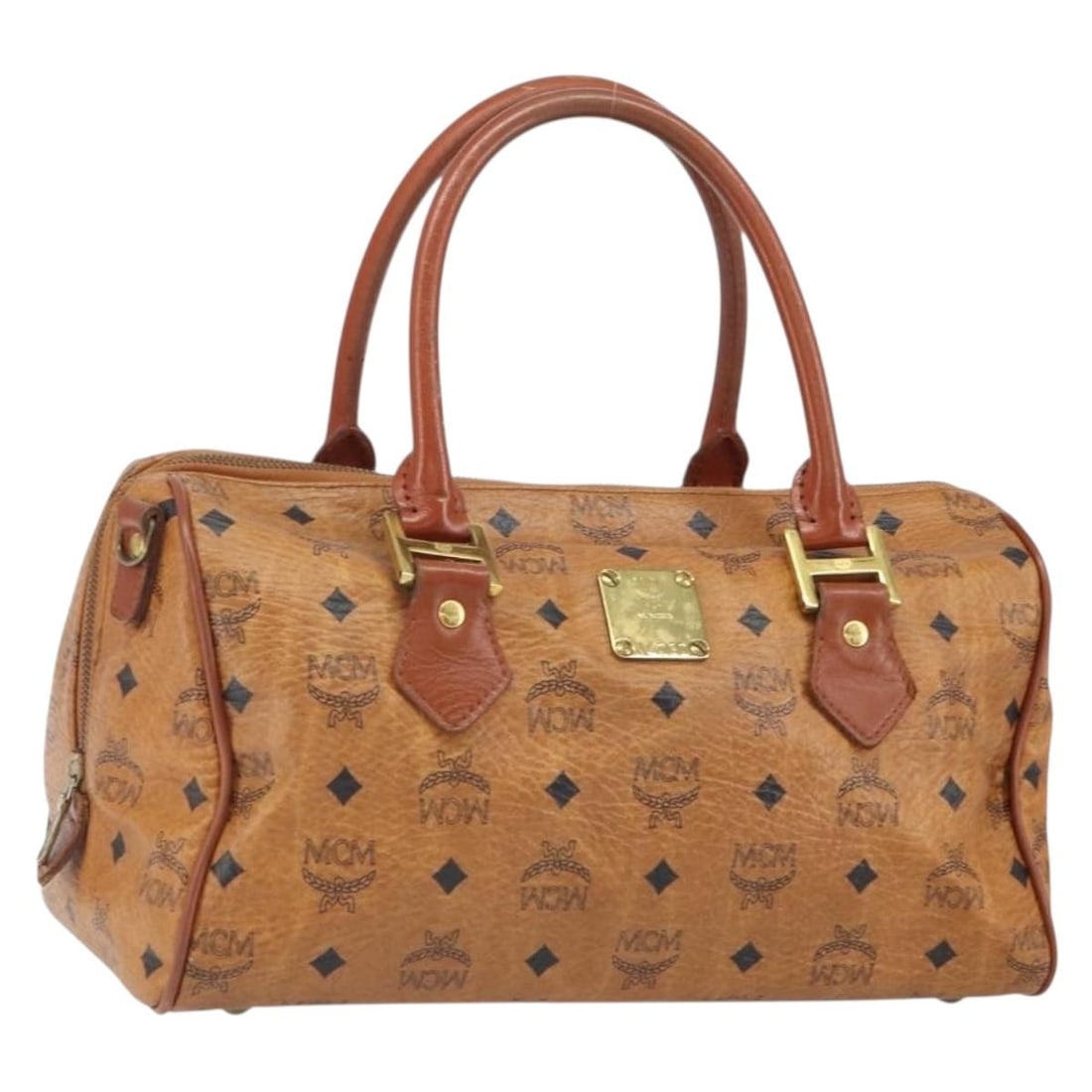 Brown PVC Leather MCM Logogram Handbag with Gold Accents: Brown PVC Leather MCM Logogram Handbag with Gold Accents This MCM Vicetos Logogram handbag features a brown and gold PVC leather exterior with distinctive brand detailing. The bag includes dual handle
