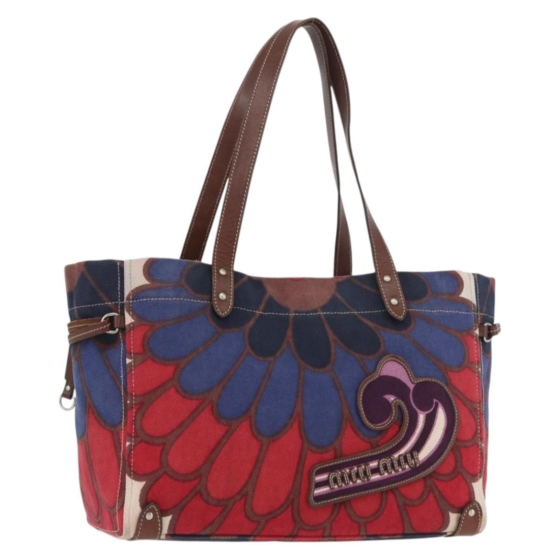 Red and Silver Canvas Tote by Miu Miu Made in Italy: Red and Silver Canvas Tote by Miu Miu Made in Italy This Miu Miu tote bag features a stylish red and silver canvas exterior. Designed for women, the bag offers a roomy interior and comfortable handles