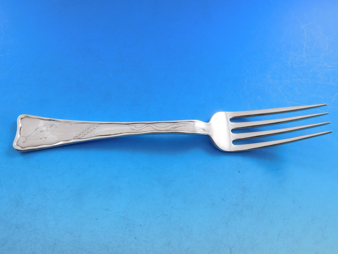 Tiffany & Co. Sterling Silver Dinner Fork Lap Over Edge Fish Snake: Tiffany & Co. Sterling Silver Dinner Fork Lap Over Edge Fish Snake This exquisite dinner fork features the elegant Lap Over Edge pattern, designed by Tiffany & Co. Crafted from high-quality sterling s