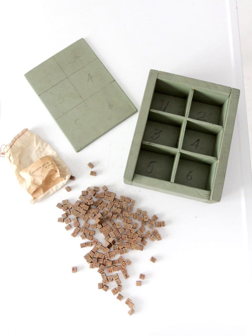 Early 20th Century Antique Wooden Number Game with 190 Hand-Marked Cubes: Early 20th Century Antique Wooden Number Game with 190 Hand-Marked Cubes This early 20th century antique wooden number game features a charming soft green painted box with six compartments, accompanie