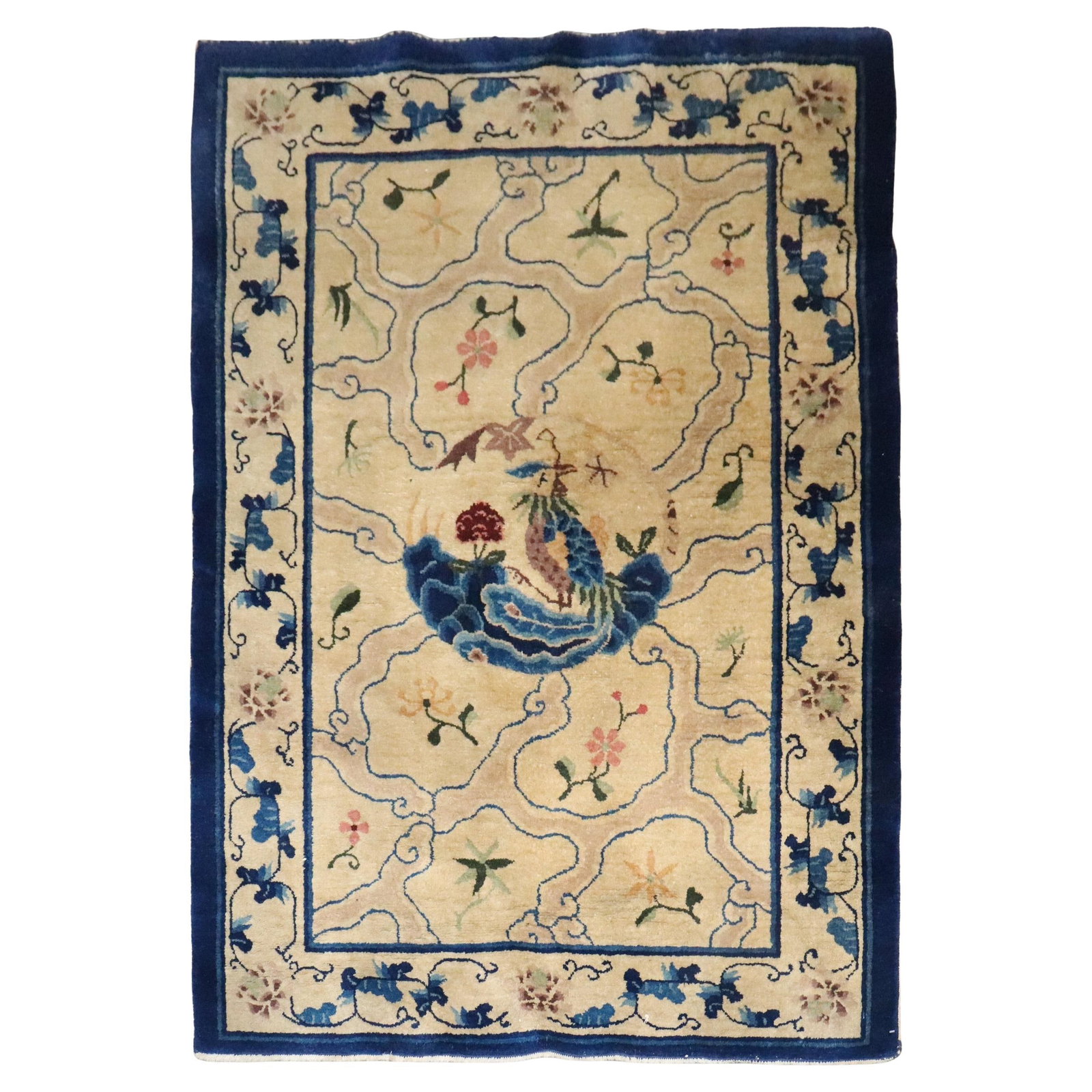 Early 20th Century Cream and Blue Chinese Wool Rug 4' x 5'8'': Early 20th Century Cream and Blue Chinese Wool Rug 4' x 5'8'' This hand-woven Chinese rug from the early 20th century features a charming floral pattern in cream and blue tones. Crafted from wool in a