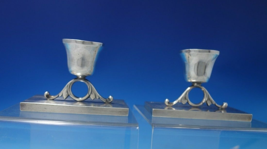 Herrera Mid-Century Sterling Silver Candle Holders Pair 1950: Herrera Mid-Century Sterling Silver Candle Holders Pair 1950 This exquisite pair of mid-century candle holders, crafted by Herrera, showcases the elegance of Mexican sterling silver. Dating back to ci