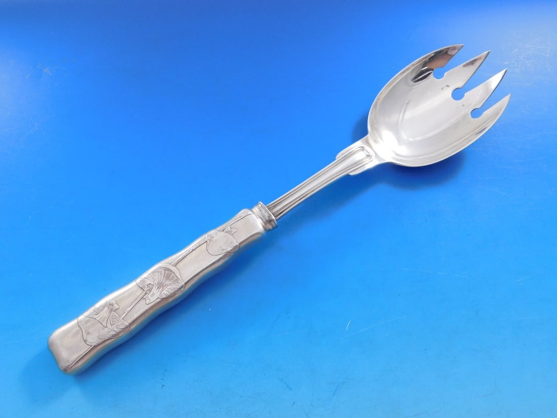 Tiffany Sterling Silver Lap Over Edge Acid Etched Buffet Spoon with Mushrooms 9 7/8": Tiffany Sterling Silver Lap Over Edge Acid Etched Buffet Spoon with Mushrooms 9 7/8" This exquisite serving spoon from Tiffany & Co. showcases the elegant Lap Over Edge Acid Etched pattern. Crafted fr
