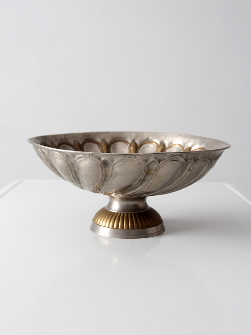 Silver Tone Pedestal Bowl With Brass Accents Hollywood Regency Style 13.5 Inch: Silver Tone Pedestal Bowl With Brass Accents Hollywood Regency Style 13.5 Inch This mid-20th century Hollywood Regency pedestal bowl features a scalloped, petal-like shape with a soft silver tone fini