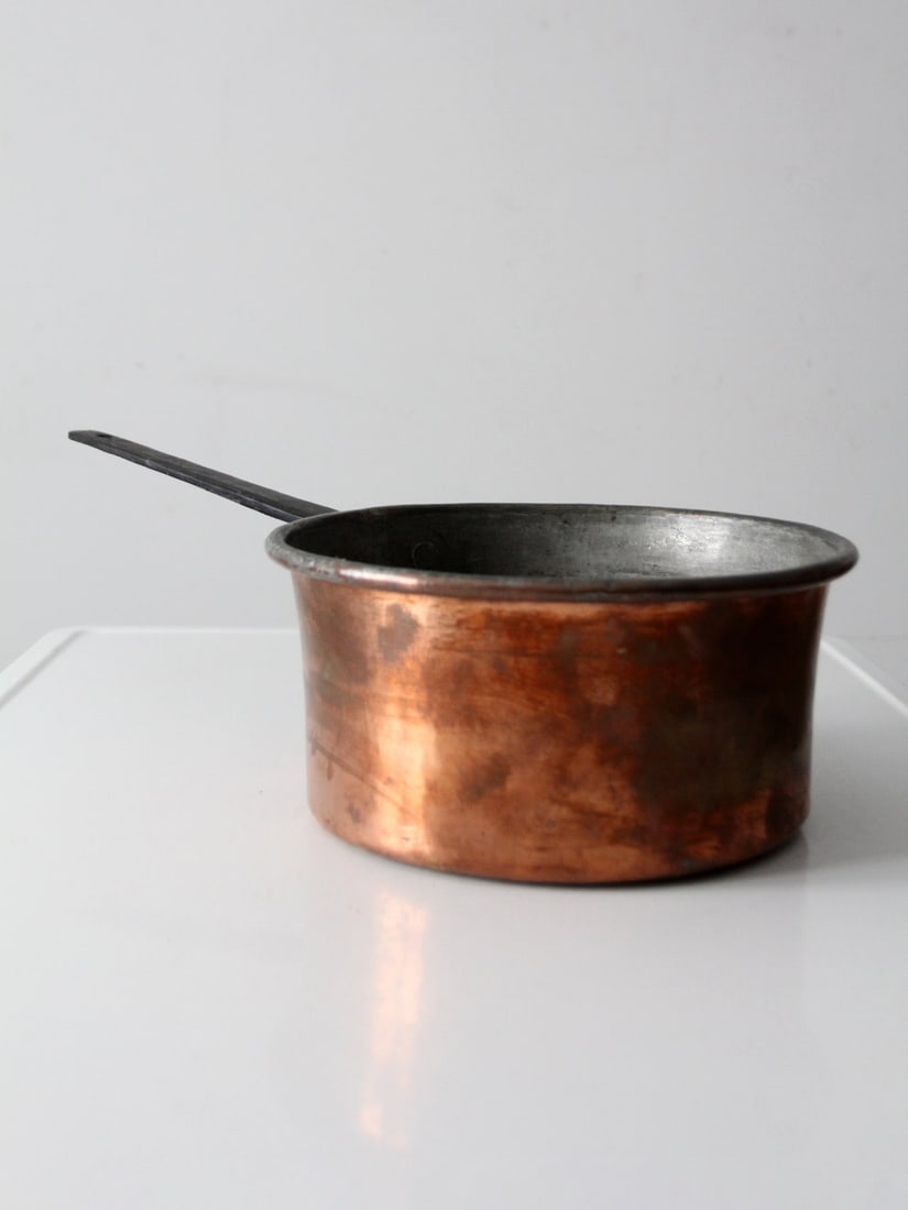 Late 19th Century Copper Saucepan Featuring Long Iron Handle: Late 19th Century Copper Saucepan Featuring Long Iron Handle This antique copper saucepan features a substantial copper body and a long iron handle secured by visible rivets, exemplifying traditional 