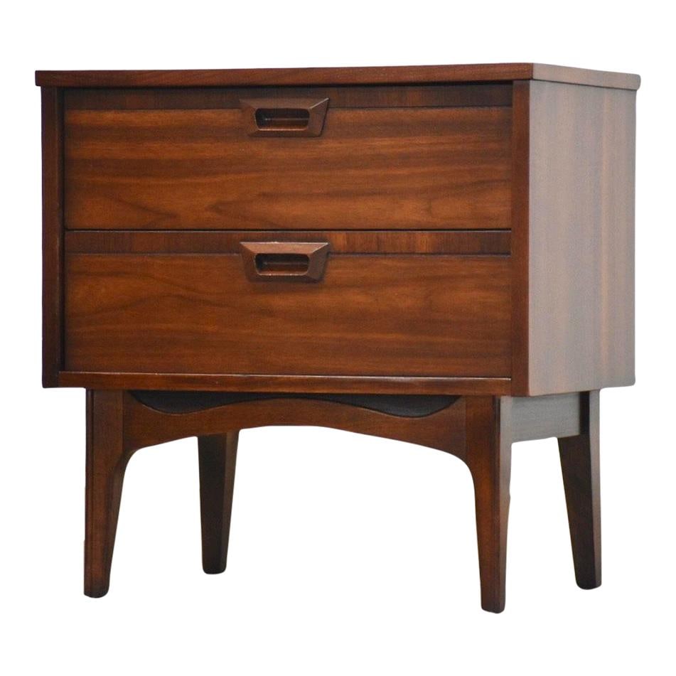 1960s Mid Century Walnut Nightstand with Two Drawers: 1960s Mid Century Walnut Nightstand with Two Drawers This 1960s mid-century modern nightstand features a beautiful walnut construction with a rich brown finish. Designed with two spacious drawers that