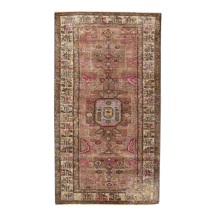 1960s Handmade Persian Geometric Wool Rug in Pink: 1960s Handmade Persian Geometric Wool Rug in Pink This stunning vintage Persian rug showcases a distressed, hand-knotted design crafted from high-quality wool. Highlighted by a vibrant pink color fiel