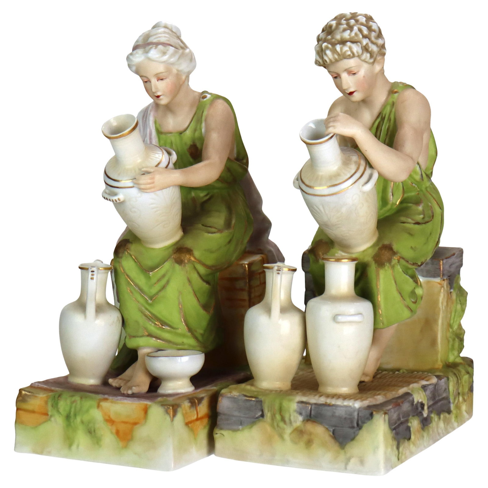 Set of Two Neoclassical Bisque Porcelain Amphora Figural Bookends Circa 1890: Set of Two Neoclassical Bisque Porcelain Amphora Figural Bookends Circa 1890 This pair of antique Neoclassical amphora figural bisque porcelain bookends features a woman and a man seated on a stone wa