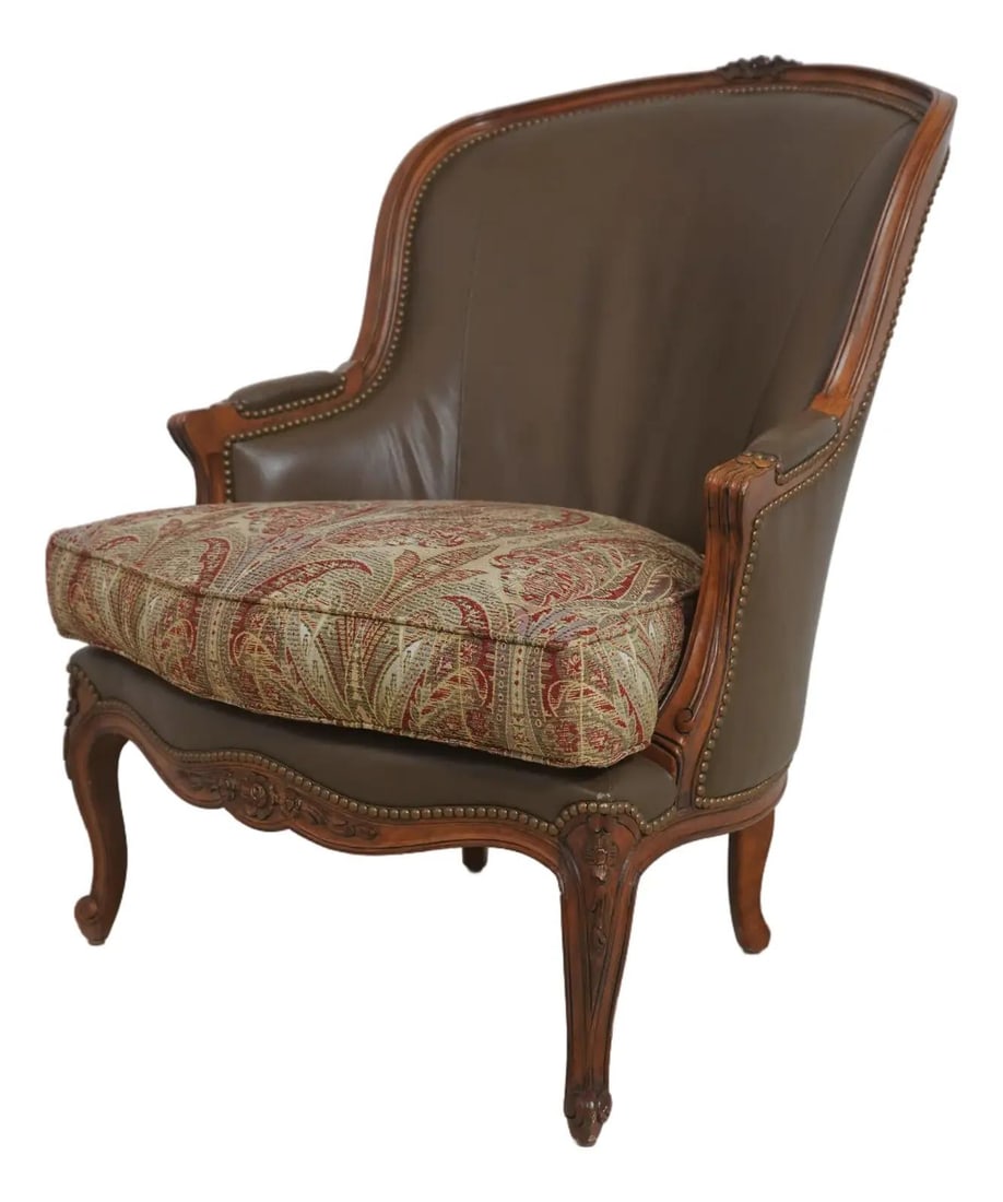 Mahogany and Leather Bergere Chair in Louis XV French Style: Mahogany and Leather Bergere Chair in Louis XV French Style This French Louis XV style bergere chair features finely carved mahogany details and a nicely tooled brown leather upholstery. The chair is 