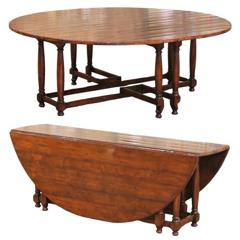 Oak Gate Leg Drop-Leaf Dining Table in Country Style by Guy Chaddock: Oak Gate Leg Drop-Leaf Dining Table in Country Style by Guy Chaddock This late 20th century dining table by Guy Chaddock features a classic English Country style with an oval drop-leaf design. Expertl