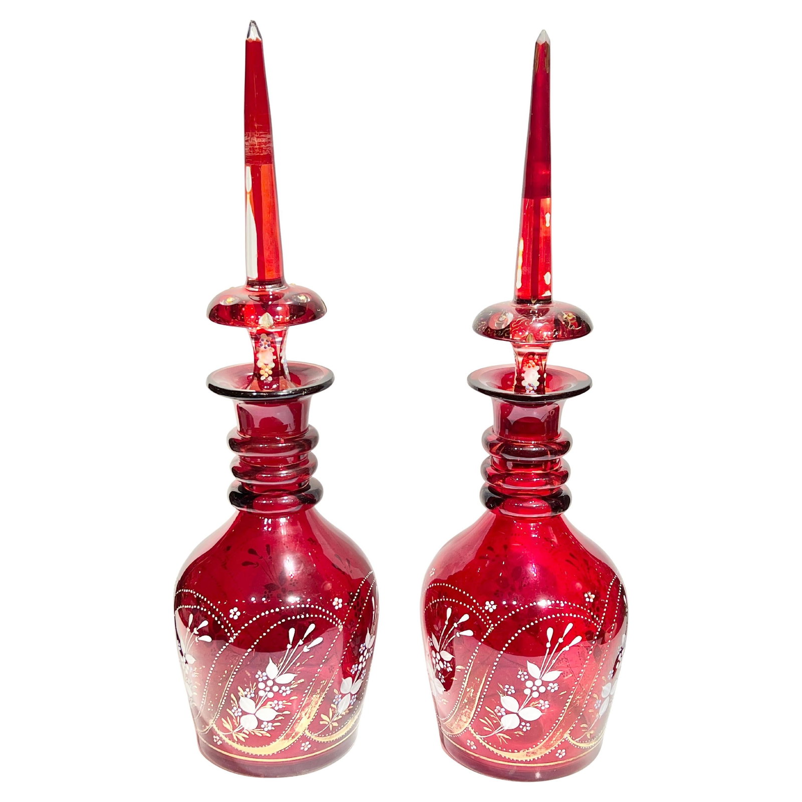 Set of Two Gilt Red Bohemian Glass Decanters with Floral Decoration: Set of Two Gilt Red Bohemian Glass Decanters with Floral Decoration This set includes two antique Bohemian red glass decanters, each adorned with floral gilt and jeweled decorations. Crafted in the la