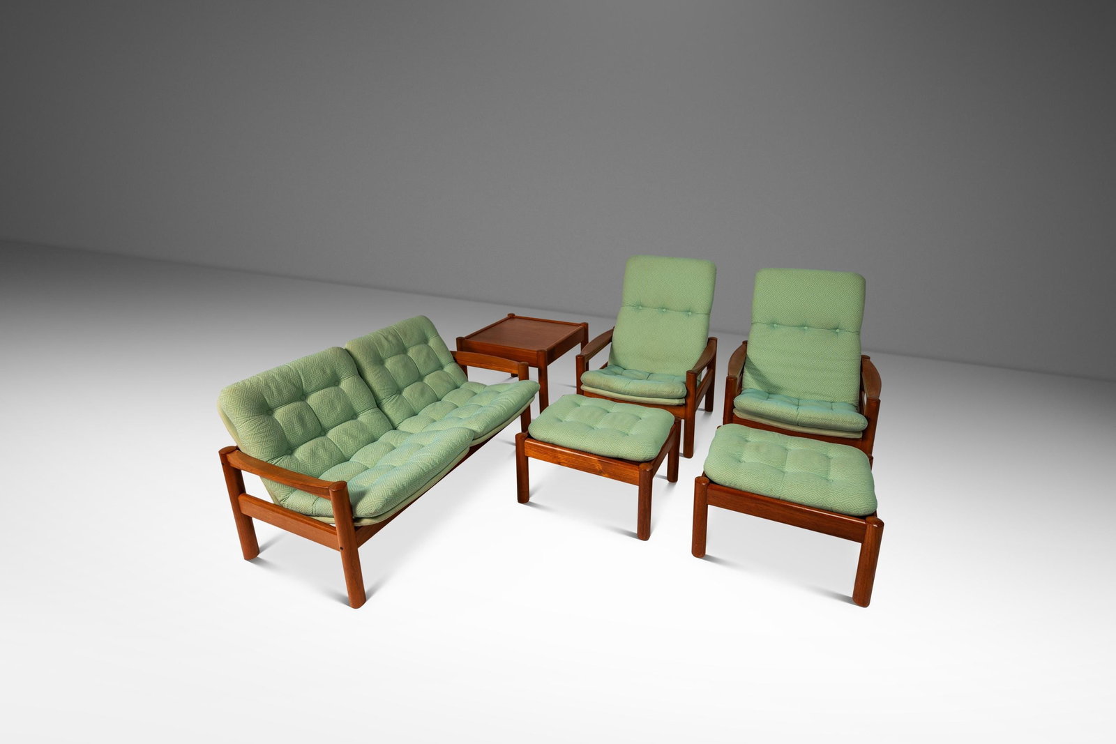Danish Teak Living Room Set by Domino Mobler 1970s Loveseat Chairs Ottomans Table: Danish Teak Living Room Set by Domino Mobler 1970s Loveseat Chairs Ottomans Table This exquisite Mid-Century Modern Living Room Set, designed by Domino Mobler in Denmark during the 1970s, includes a l