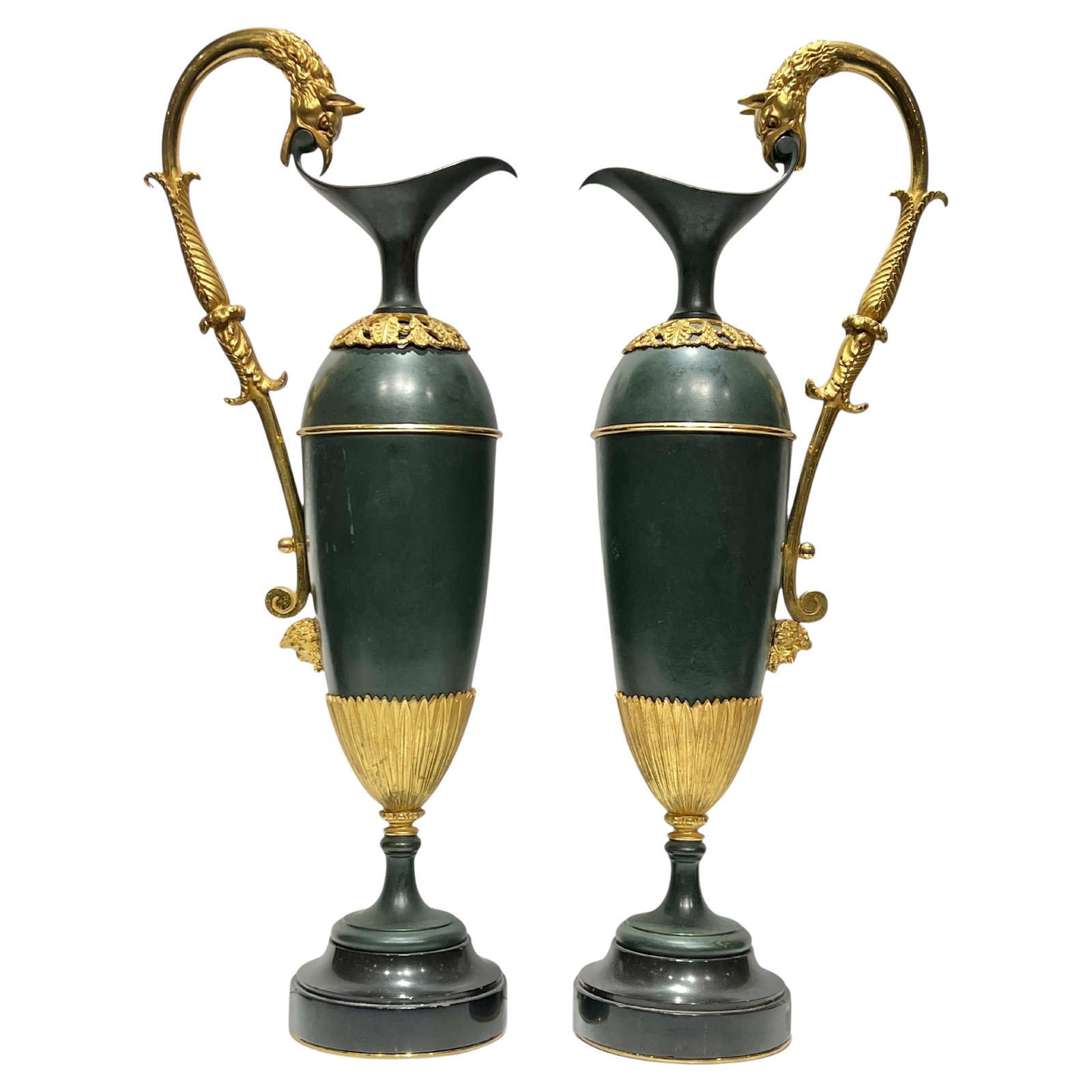 Set of 2 French Empire Bronze and Gilt Ewers on Marble Bases: Set of 2 French Empire Bronze and Gilt Ewers on Marble Bases This pair of 19th-century French Empire style ewers features urn-shaped bodies crafted in patinated bronze with rich green tones. Each ewer