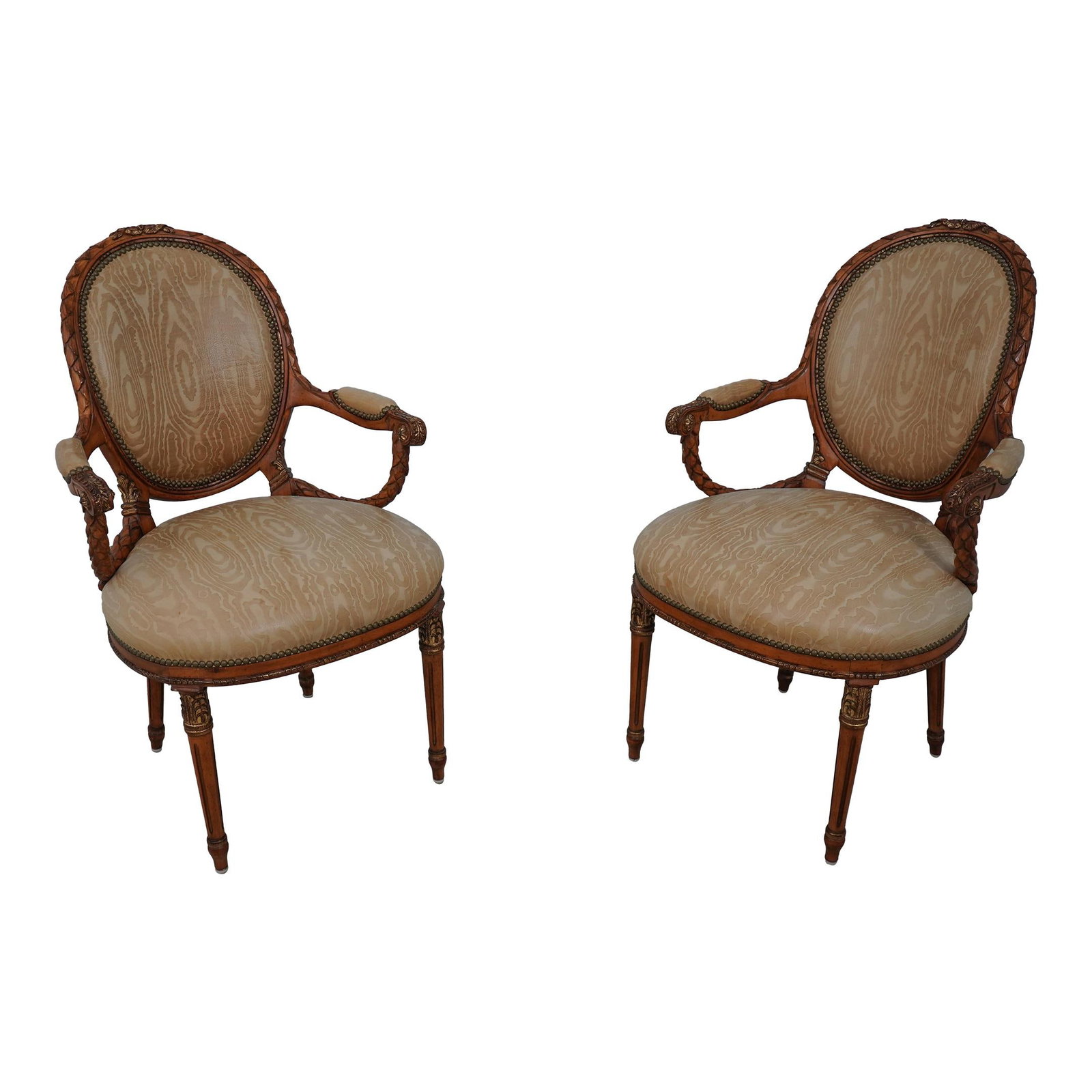 Luxurious Pair of French Louis XVI Carved Leather Armchairs: Luxurious Pair of French Louis XVI Carved Leather Armchairs This exquisite pair of French Louis XVI open armchairs showcases elegant craftsmanship with intricate carvings and gold highlights. Construc