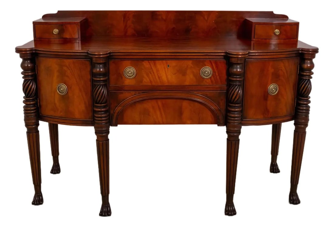 Empire Design Mahogany Sideboard with Brass Accents and Carved Paw Feet: Empire Design Mahogany Sideboard with Brass Accents and Carved Paw Feet This Empire style sideboard from the 1990s is crafted by Henredon and features intricate figural mahogany throughout. The piece 