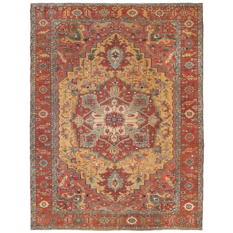 Oversized Early 1900s Serapi Wool Rug Hand-Knotted in Iran 11'8" x 15'3": Oversized Early 1900s Serapi Wool Rug Hand-Knotted in Iran 11'8" x 15'3" This oversized antique Serapi carpet from the early 20th century features a classical ivory and tomato central medallion on a u