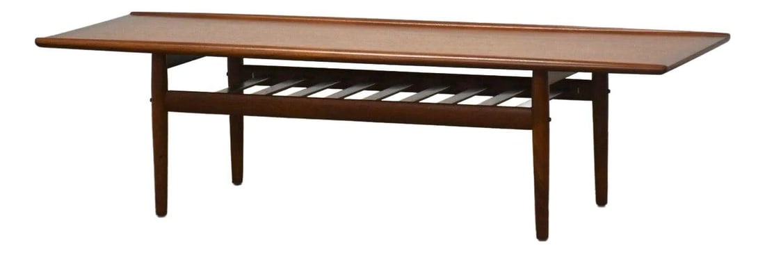 1960s Grete Jalk Teak Coffee Table with Slatted Magazine Rack: 1960s Grete Jalk Teak Coffee Table with Slatted Magazine Rack This exquisite mid-century modern teak coffee table, designed by Grete Jalk for Glostrup, showcases a stylish slatted magazine rack beneat