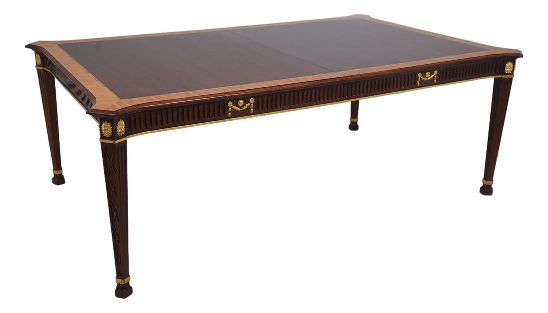 Neoclassical Mahogany Dining Table with Satinwood Accents and Carved Fretwork: Neoclassical Mahogany Dining Table with Satinwood Accents and Carved Fretwork This John Widdicomb neoclassical dining room table is crafted from mahogany and features drape carved and fine carved deta