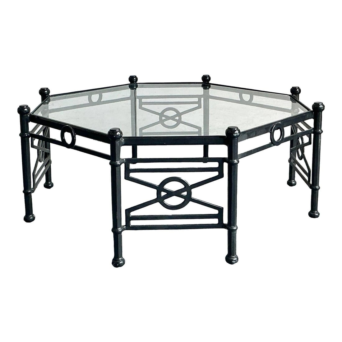 Octagonal Glass Top Coffee Table With Black Cast Aluminum Base And Target Motif: Octagonal Glass Top Coffee Table With Black Cast Aluminum Base And Target Motif This vintage octagonal coffee table showcases the bold style of Hollywood Regency design. It features a robust cast alum