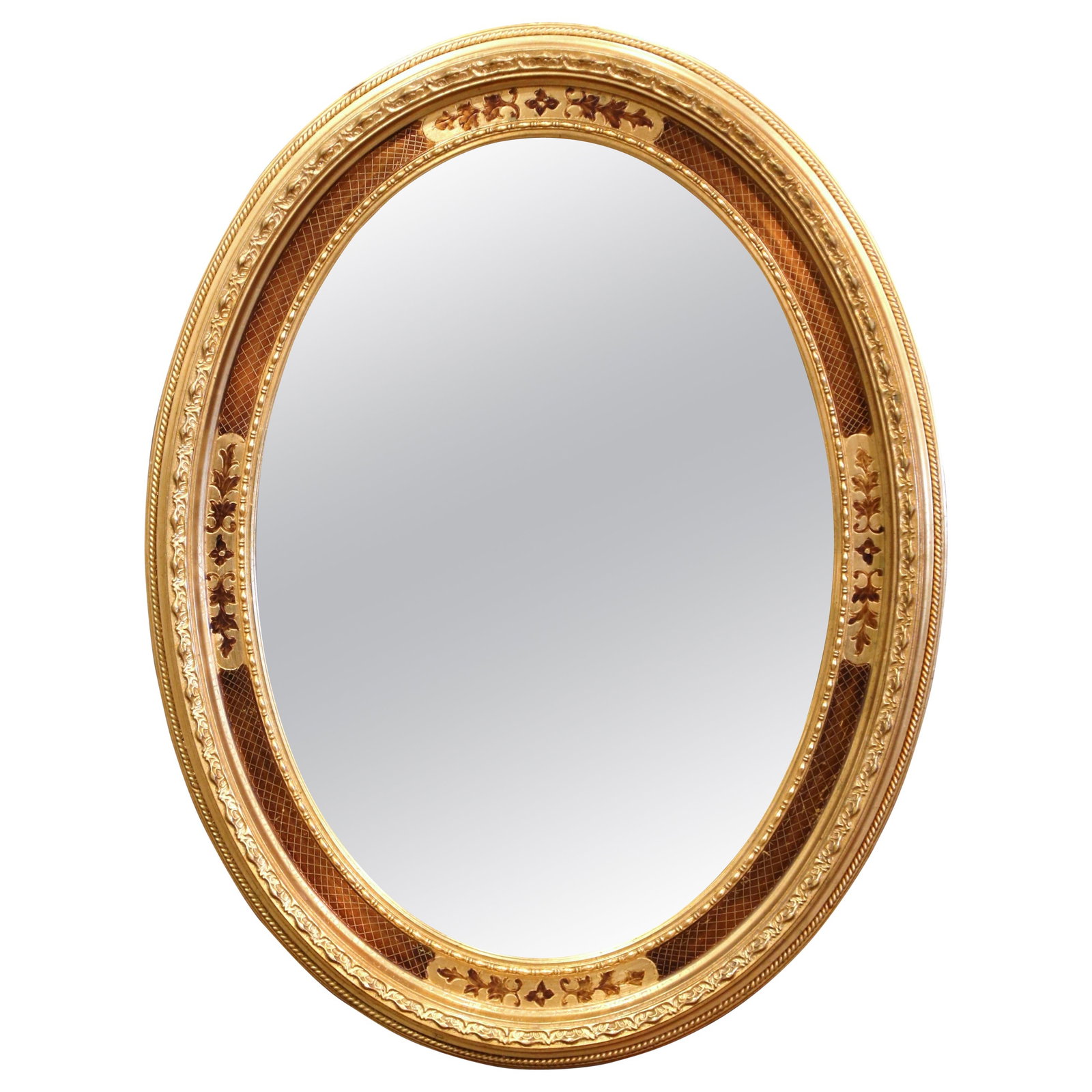 French Oval Wall Mirror with Gilt Floral Inlay Circa 1950: French Oval Wall Mirror with Gilt Floral Inlay Circa 1950 This mid-20th century French oval wall mirror is crafted in the Napoleon III style and features a finely hand-carved giltwood frame with intri