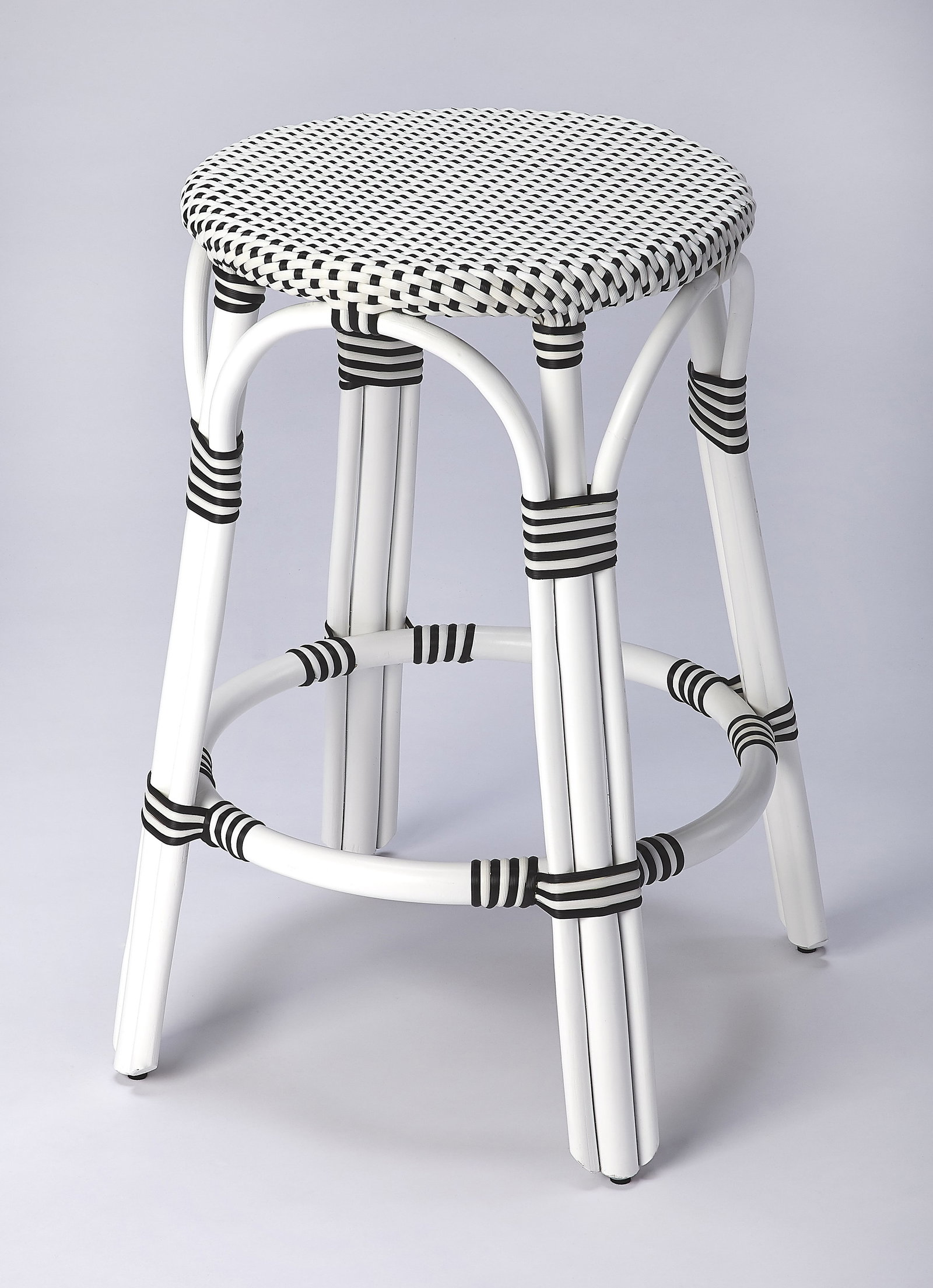 Butler Tobias Coastal Style Black Dot Rattan Counter Stool: Butler Tobias Coastal Style Black Dot Rattan Counter Stool Elevate your dining or entertainment space with this Chic Black Dot Mediterranean Rattan Barstool. Designed with a round shape and a stylish 