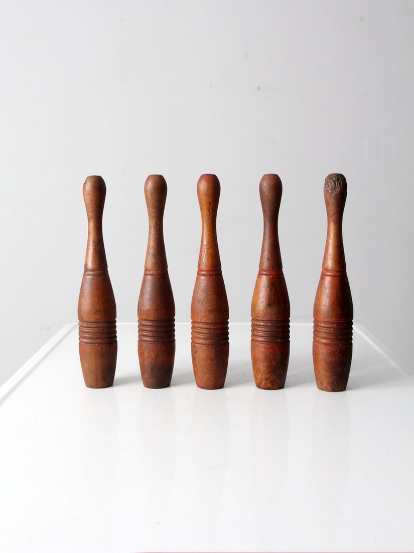 Antique Wooden Skittles Set of 5 with Red Accents: Antique Wooden Skittles Set of 5 with Red Accents Discover this charming set of five antique wooden skittles, perfect for collectors and vintage game enthusiasts. Each skittle is crafted from turned w