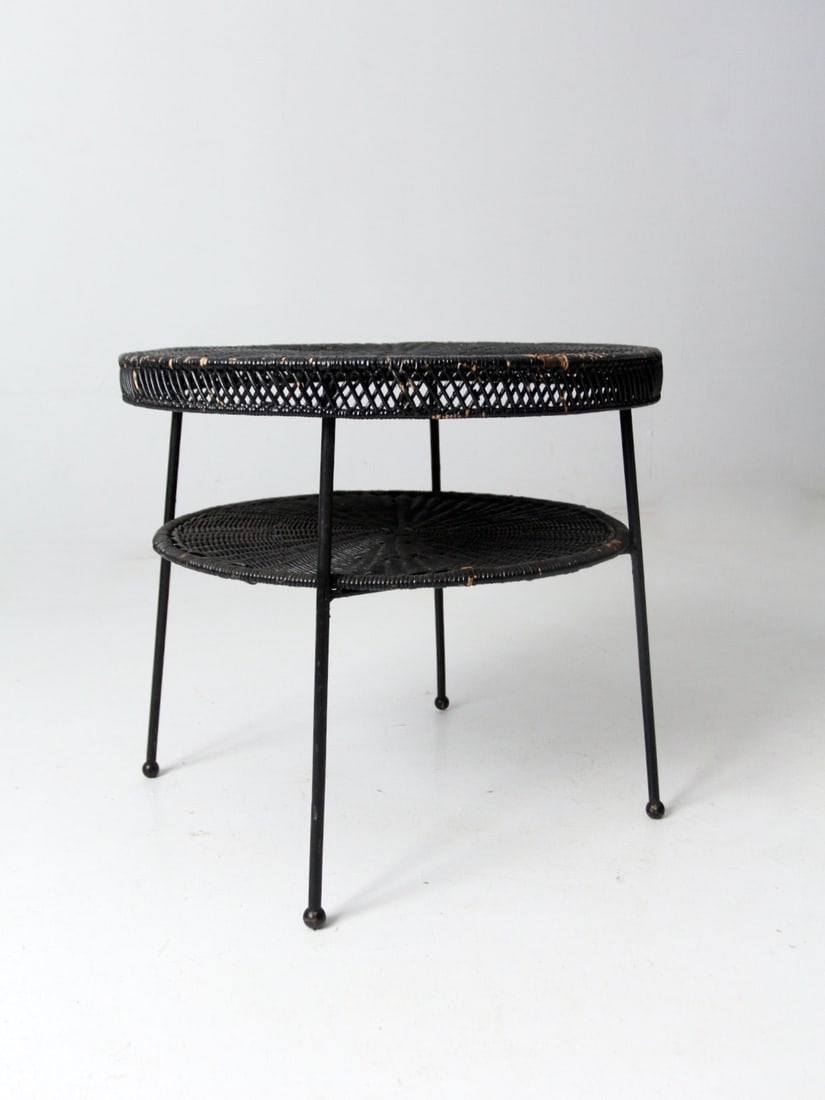 Mid Century Two-Tier Black Wicker Accent Table with Metal Legs: Mid Century Two-Tier Black Wicker Accent Table with Metal Legs This Mid Century Black Wicker Side Table showcases a stylish two-tier design, featuring round woven surfaces complemented by slim metal l