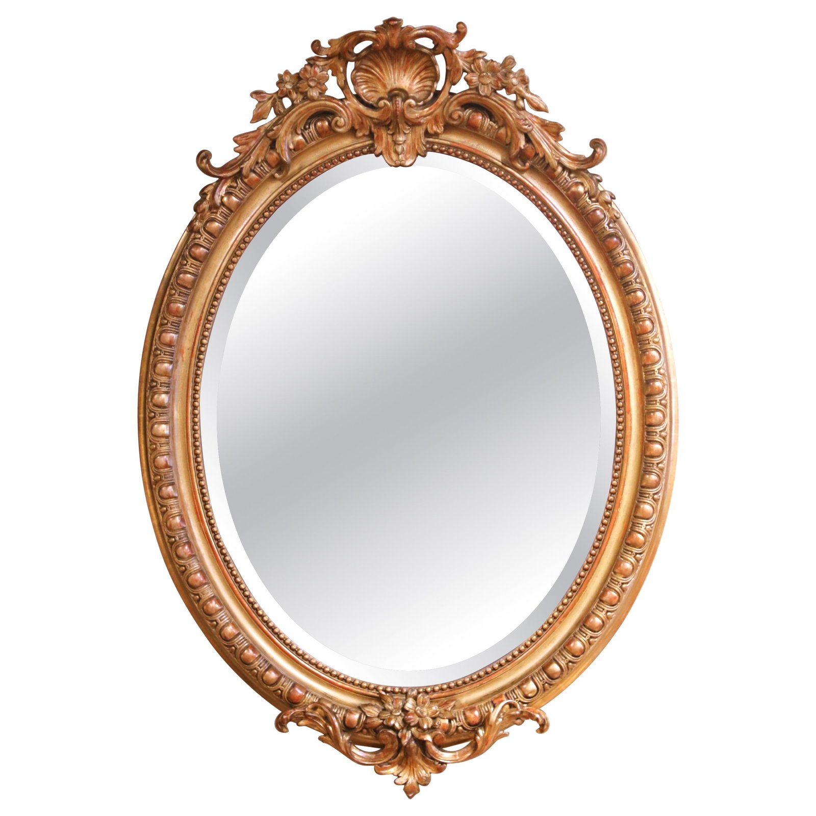 French Louis XV Oval Giltwood Mirror with Beveled Mercury Glass circa 1860: French Louis XV Oval Giltwood Mirror with Beveled Mercury Glass circa 1860 This mid-19th century French Louis XV oval wall mirror features a hand-carved giltwood frame with a rich gilt finish and subt