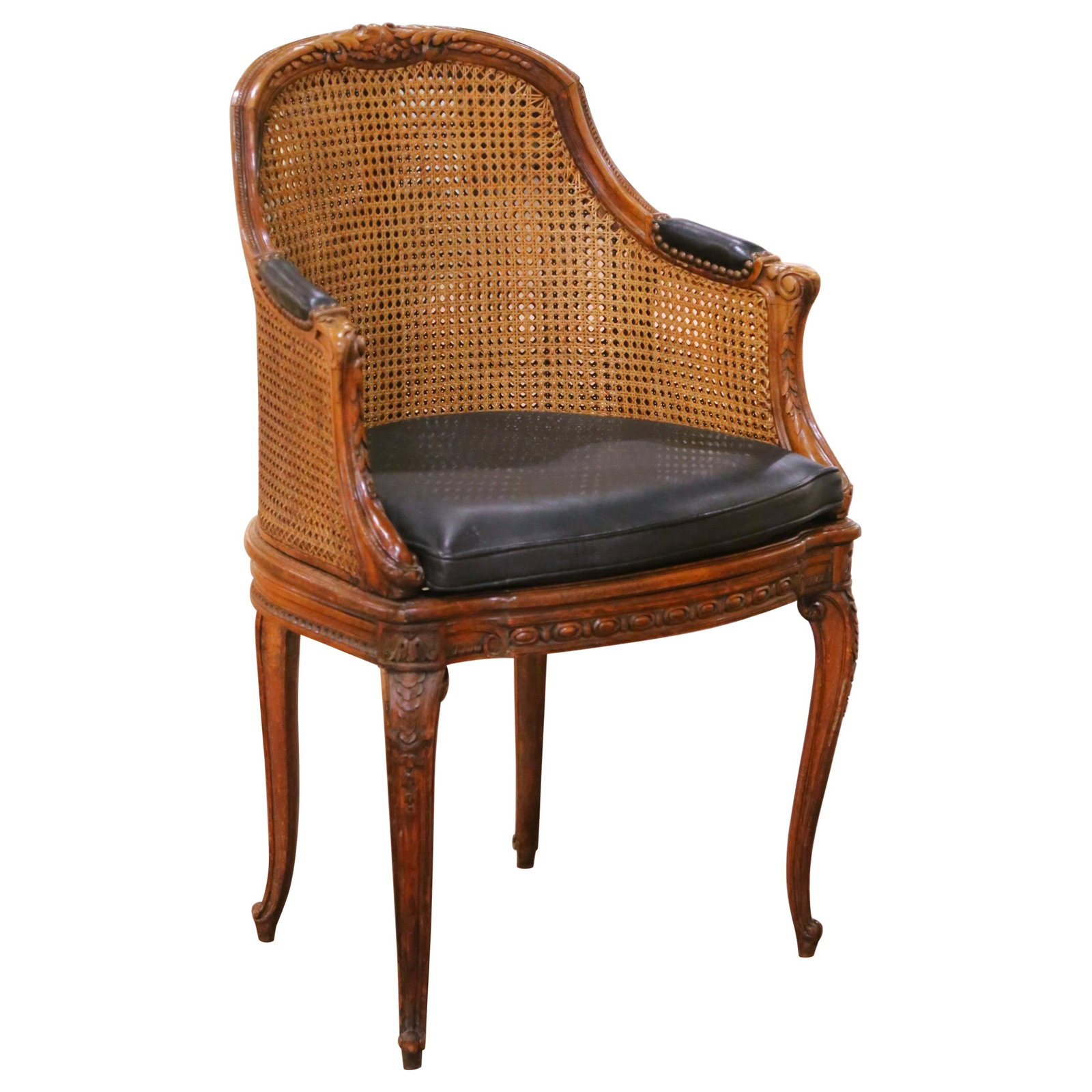 French Louis XV Barrel Back Walnut Armchair with Cane Panels and Leather Seat: French Louis XV Barrel Back Walnut Armchair with Cane Panels and Leather Seat This late 19th century French Louis XV armchair is crafted from solid walnut and features a double caned barrel-form back 