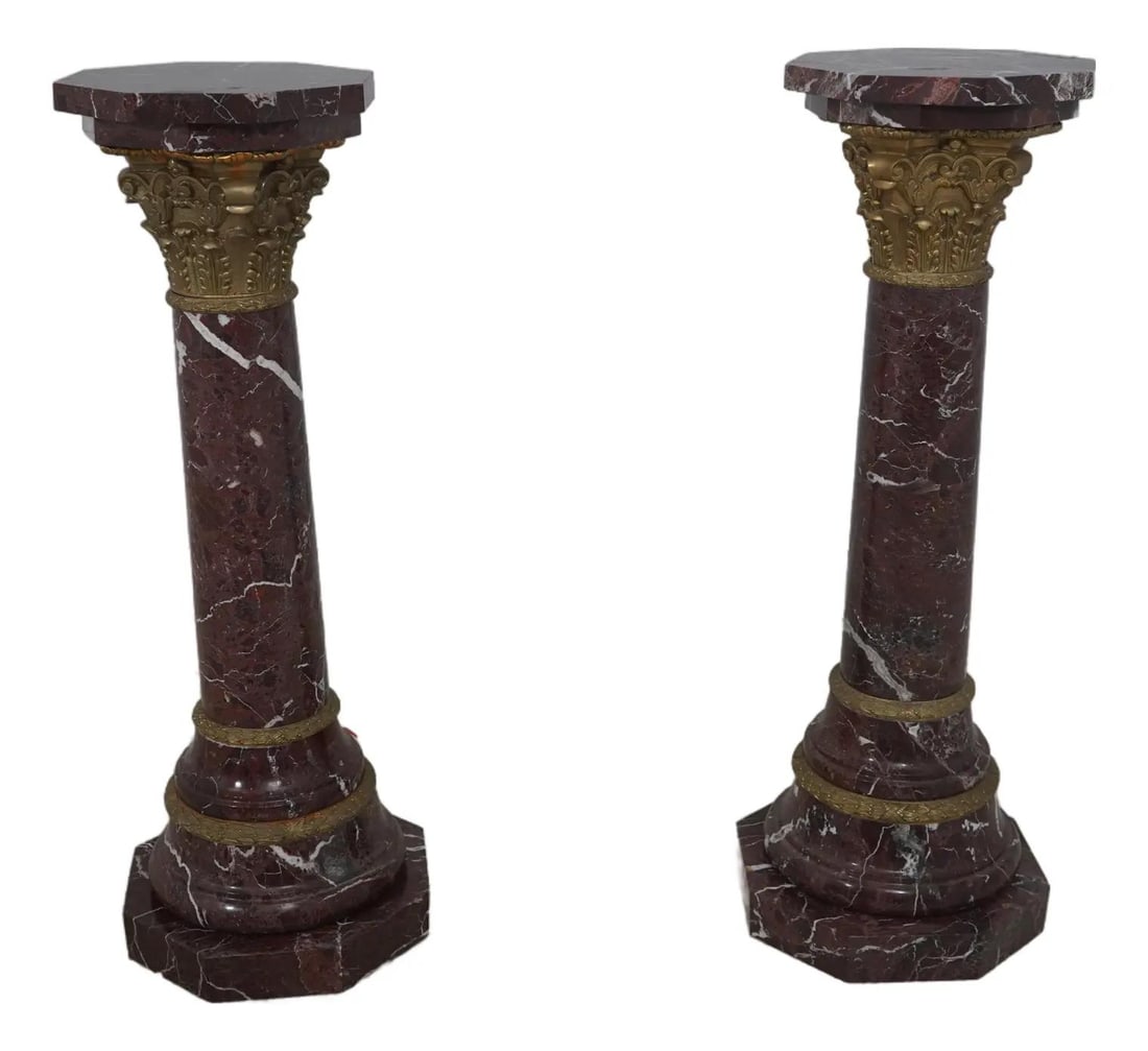 Pair of French Empire Marble and Bronze Pedestals 100 Years Old: Pair of French Empire Marble and Bronze Pedestals 100 Years Old This exquisite pair of French Empire column pedestals showcases stunning reddish marble with high-quality bronze trim, reflecting their 