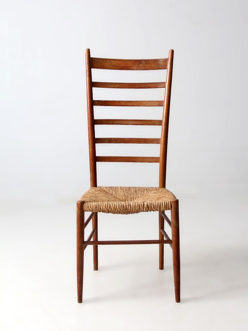 Early 20th Century Ladderback Chair with Woven Rush Seat: Early 20th Century Ladderback Chair with Woven Rush Seat This early 20th century ladderback chair features slender posts framing gently curved slats, creating an elegant vertical silhouette. The woven
