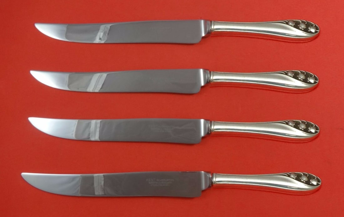 Lily of the Valley Gorham Sterling Silver Texas Sized Steak Knife Set 4 Piece: Lily of the Valley Gorham Sterling Silver Texas Sized Steak Knife Set 4 Piece Elevate your dining experience with this exquisite 4-piece set of Lily of the Valley steak knives by Gorham. Crafted from 