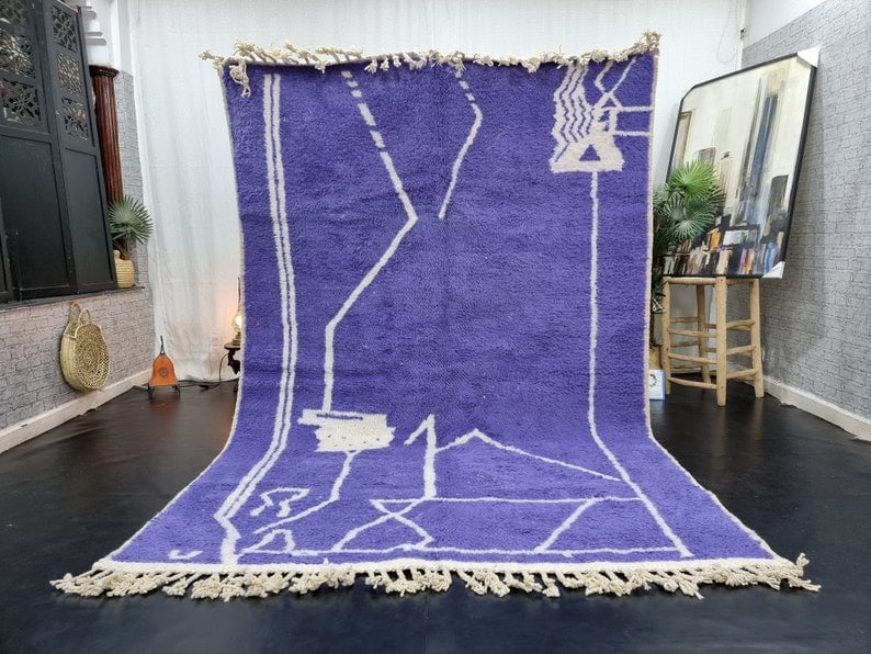 Authentic Soft Purple Moroccan Berber Wool Area Rug 9.84 x 6.56 Feet: Authentic Soft Purple Moroccan Berber Wool Area Rug 9.84 x 6.56 Feet This Elegant Soft Purple Moroccan Berber Wool Area Rug is a stunning addition to any space. Handwoven in the Atlas Mountains by ski
