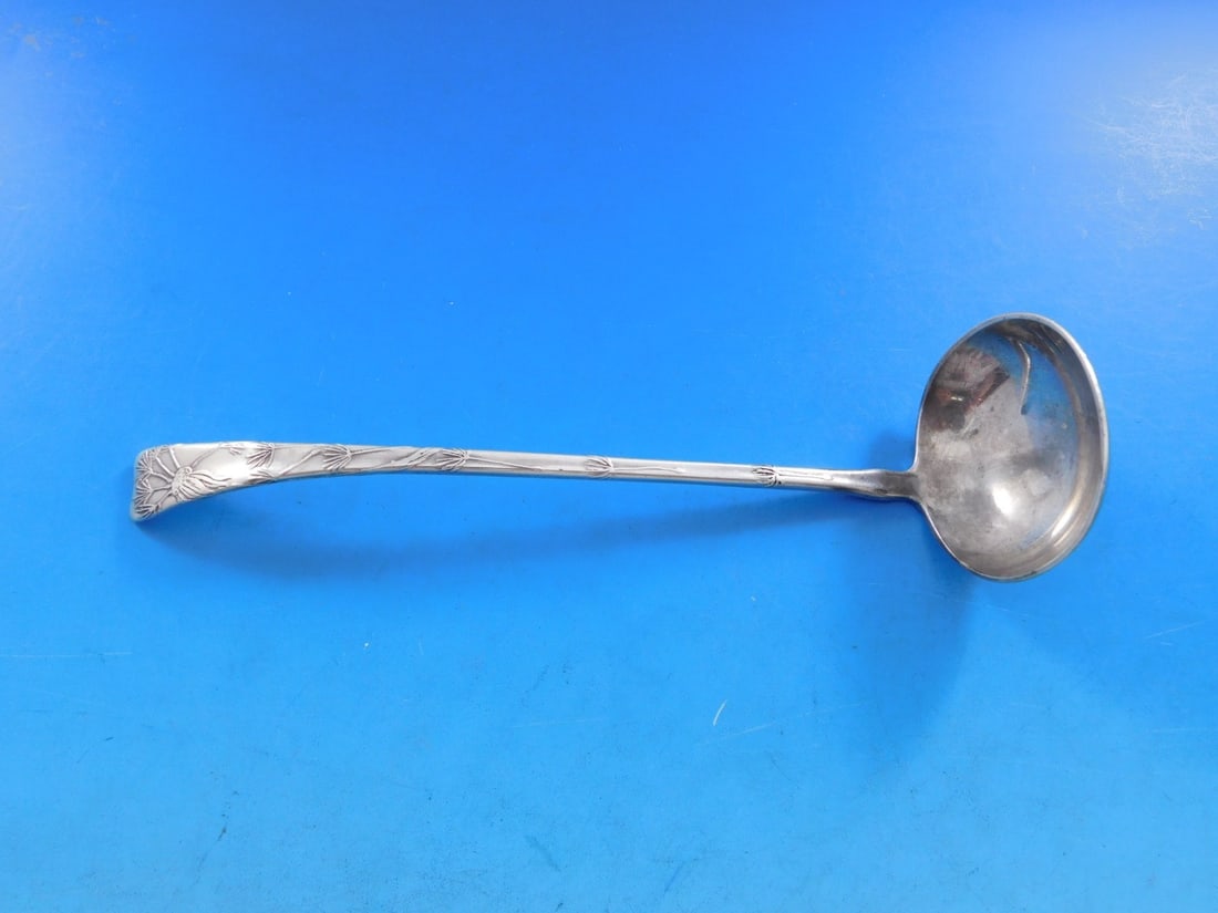 Tiffany Sterling Silver 7 Inch Dandelion Sauce Ladle Lap Over Edge: Tiffany Sterling Silver 7 Inch Dandelion Sauce Ladle Lap Over Edge This exquisite sauce ladle by Tiffany & Co. features a stunning dandelion motif and showcases the Lap Over Edge pattern. Made from hi